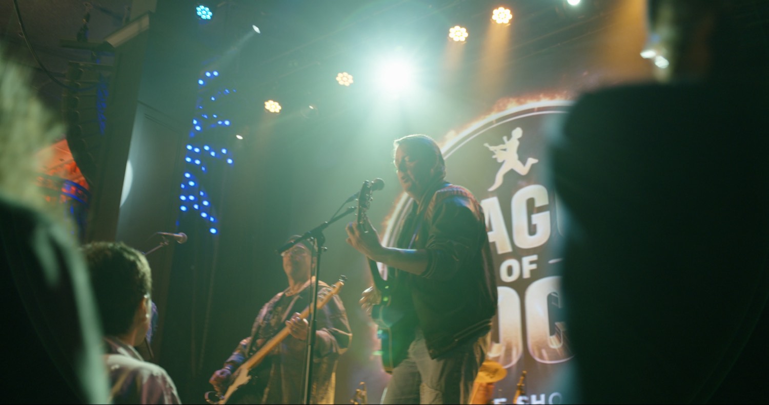 Band performing under stage lights